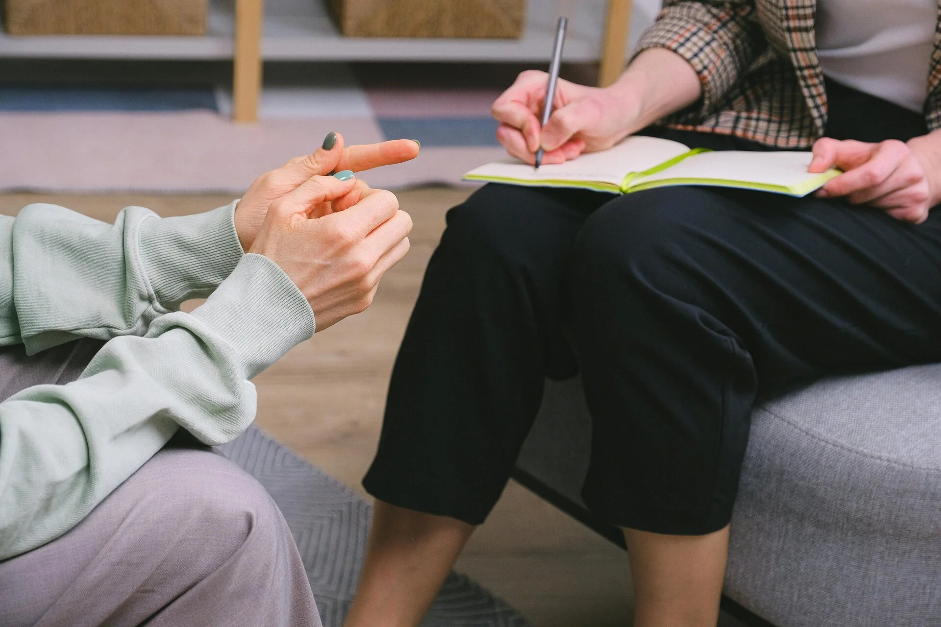 A counsellor offering support to a woman with a hand on her shoulder